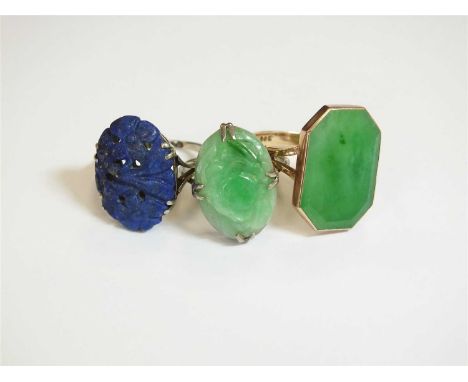 A jade panel ring, the canted rectangular jade plaque collet set in yellow metal and mounted to yellow metal shank, stamped '