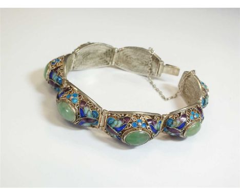 An oriental white metal, jade and enamel panel bracelet, designed as seven links each set with a central oval jade cabochon, 