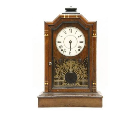 An early 20th century Seth Thomas walnut mantel clock, the circular dial with Roman numerals and visual pendulum, 50cm high