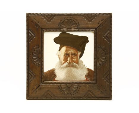 A painted ceramic tile of a man with a beard, in a chip carved frame (Italian tile), 18cm square overall