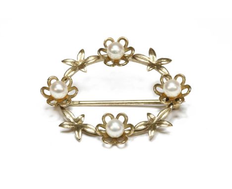 A 9ct gold oval wreath brooch, with applied flower head and leaves, each flower set with a cultured pearl, hallmarked 9ct gol