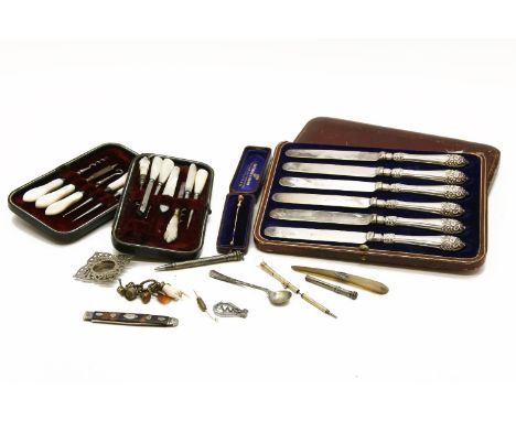 Silver handled knives, gold and coral tie pin, mother of pearl cased implements, and a quantity of miscellaneous items to inc