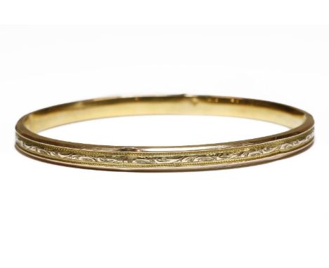 A 9ct gold hollow slave bangle, with engraved central band decoration, 19248.00g