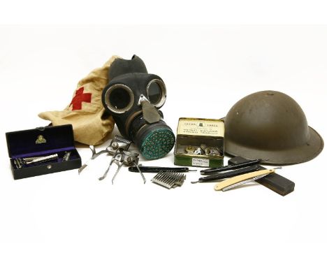 A collection of militaria, to include a WWII Brodie helmet with canvas strap and liner, a gas mask in original bag, a quantit