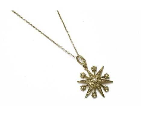 A late Victorian gold split pearl star pendant on chain, pendant marked 15ct, chain tested and valued as 9ct gold4.82g