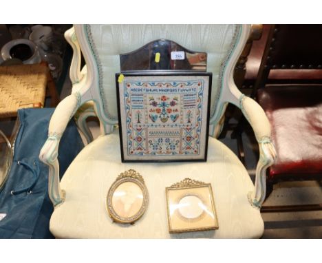 A modern sampler and an easel mirror and two brass easel picture frames with whiter stone decoration