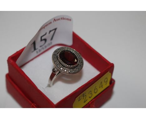 A vintage Sterling silver ring set with garnet and marcasite stones, size M/N