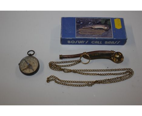 A Bosun's whistle with original box and a compass