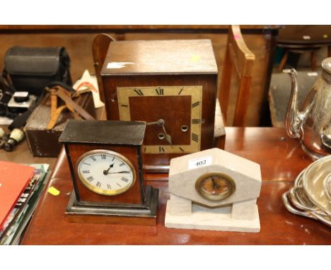 An oak cased three hole mantel clock; and two other mantel clocks 