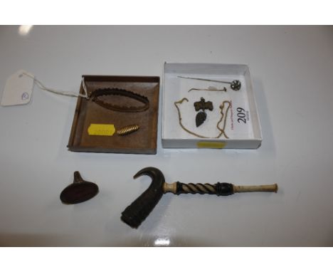 A 9ct gold mount, approx. weight 6.5gms; and a horn and bone pipe; a yellow metal inlaid pendant; a hardstone seal etc.