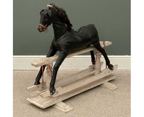 VINTAGE ROCKING HORSE, black vinyl covering, stripped pine base, 89 (h) x 101 (w) x 48cms (d)Provenance: deceased estate Conw