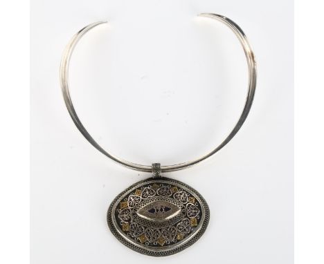 A large Continental Folk Art filigree pendant, unmarked white metal settings with applied brass flowerheads, on Danish sterli