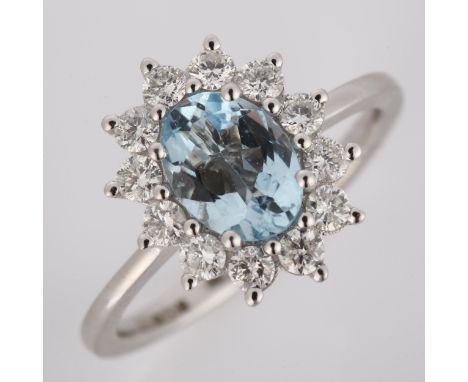 A modern 18ct white gold aquamarine and diamond cluster ring, set with oval mixed-cut aquamarine and modern round brilliant-c