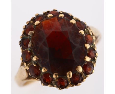 A late 20th century 9ct gold garnet cluster dress ring, setting height 16.6mm, size O, 4.6gNo damage or repairs, all stones p