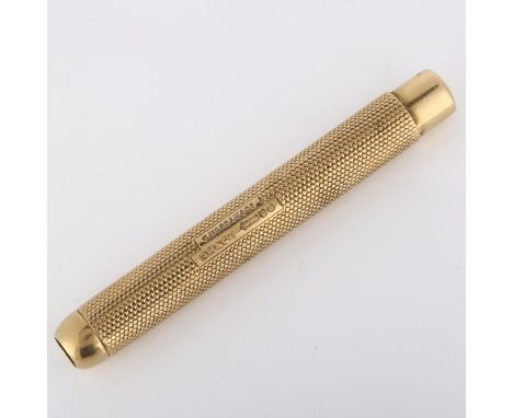 SAMPSON MORDAN & CO - an early 20th century 9ct gold gravity propelling pencil, allover engine turned decoration with push-bu