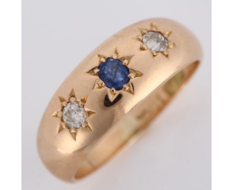 An early 20th century 15ct rose gold three stone sapphire and diamond gypsy ring, total diamond content approx 0.2ct, maker's