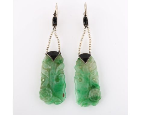 A pair of Art Deco jade onyx and seed pearl drop earrings, with carved and polished jade panels depicting blossom, with unmar