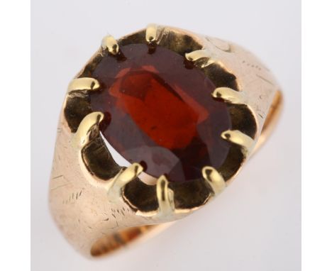 An early 20th century 9ct rose gold garnet dress ring, set with oval mixed-cut garnet and engraved shoulders, indistinct hall