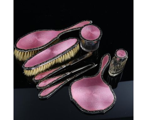 An Art Deco George V silver and pink/black enamel 8-piece dressing table set, including hand mirror, manicure tools and glass