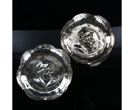 A pair of Edwardian novelty silver "The Artful Dodger" dishes, circular form with relief embossed figural decoration and crim