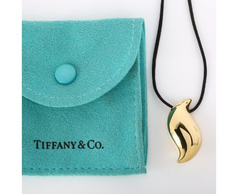 TIFFANY & CO - an 18ct gold Feather pendant necklace, by Elsa Peretti, on black cord, hallmarks London 2007, pendant height 3