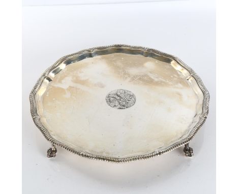A George V circular silver salver, gadrooned rim with claw and ball feet, by Goldsmiths & Silversmiths Co Ltd, hallmarks Shef