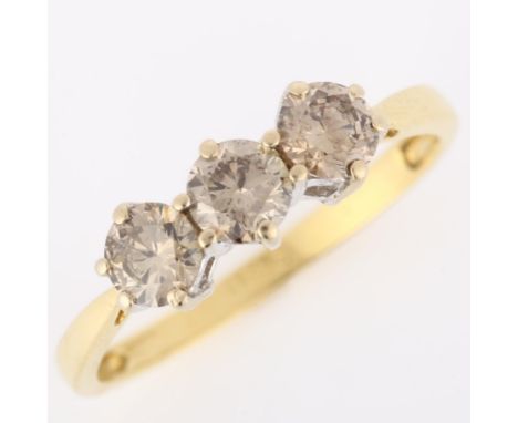 An 18ct gold three stone brown diamond ring, claw set with modern round brilliant-cut diamonds, clarity approx SI2/SI3, total