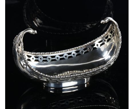 GARRARD & CO LTD - a George V silver gondola sweetmeat dish, with pierced rim and engraved armorial crest, hallmarks London 1
