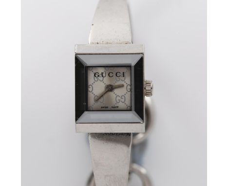 GUCCI - a lady's stainless steel quartz bracelet watch, ref. 128.5, square GG monogram dial with mirror bezel and bangle brac