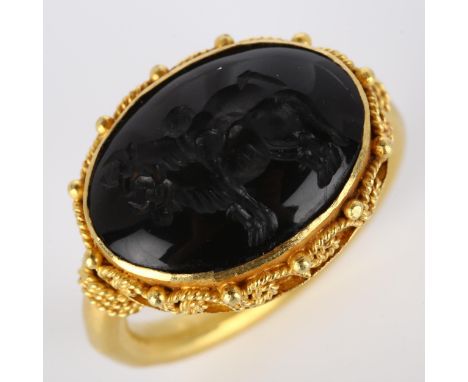 A Victorian style seal ring, unmarked high carat gold settings with wirework surround and intaglio carved stone depicting 2 b