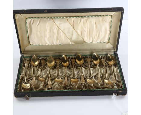A set of 12 Continental silver teaspoons, with relief flaming torch decoration, marked 750, length 10.5cm, 2.8oz total, cased