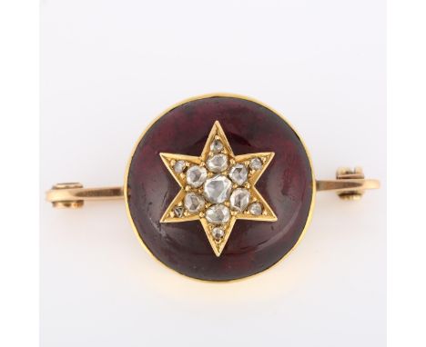A large Victorian garnet and diamond starburst bar brooch, unmarked gold closed-back settings with large round cabochon foil-