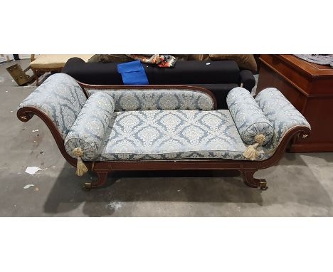 Regency sofa in blue ground foliate upholstery, outswept legs with brass caps and castors Condition ReportSurface scratches, 