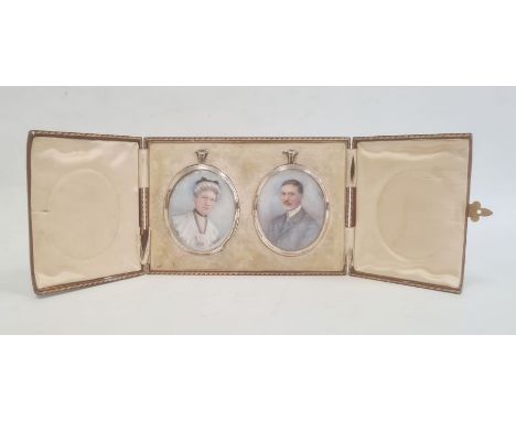 Pair of Edwardian portrait miniatures on ivory depicting a lady and gentleman, signed with monogram 'GM' and each in oval sil