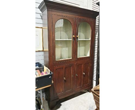 Shabby chic-style display cabinet, the moulded cornice above two arched glazed doors enclosing shelf, two cupboard doors unde