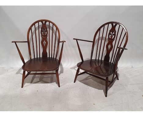 Pair of dark elm Ercol low armchairs with carved and pierced backsplats, on turned supports and stretchers (2) 