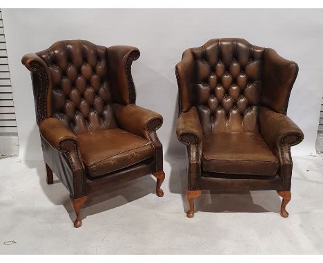 Two similar brown leather buttonback wing back armchairs, each on cabriole legs (2) Condition ReportFirst chair (Pictured lef