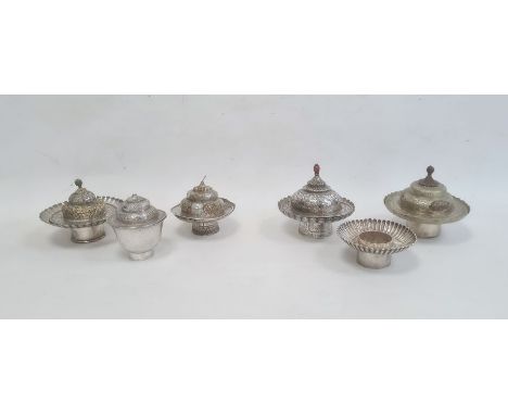Six various engraved and shaped silver-coloured bowls and cups and five various domed covers, all profusely chased and some p