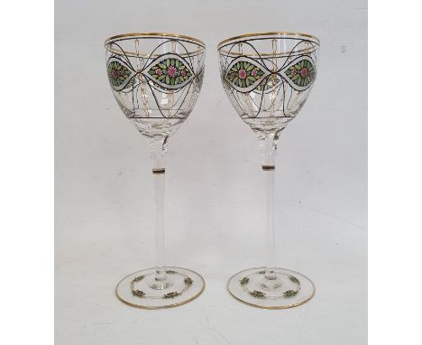 Pair of wine glasses on slender stems in the manner of Theresienthal, the bowls and feet painted with stylised floral decorat