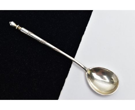 A WHITE METAL CONDIMENT SPOON, the spoon with enamel detail to the reverse, with twist detail handle and finial, with partial