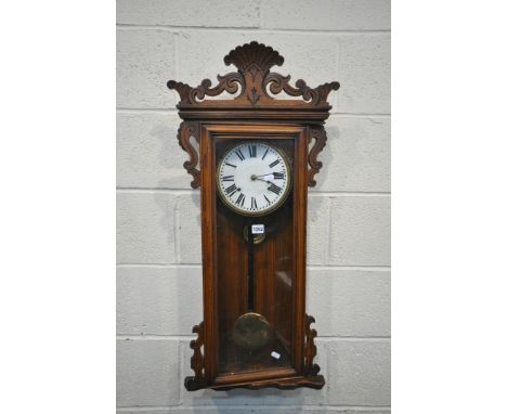 A STAINED OAK WALL CLOCK, the 7 inch enamel dial, with roman numerals, with a pendulum, height 92cm