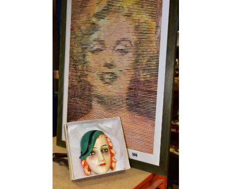 AN ART DECO GOEBEL FACE MASK, of a red haired lady wearing a green hat, impressed backstamp verso, approximate length 15.5cm 