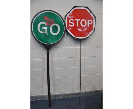 TWO VINTAGE STOP AND GO SIGNS comprising a steel sign and another plastic stop and go sign, along with two vintage telescopic