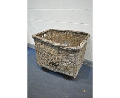 A VINTAGE WICKER MILL BASKET, on four wheels, length 80cm x depth 69cm x height 72cm (condition - in need of restoration, due