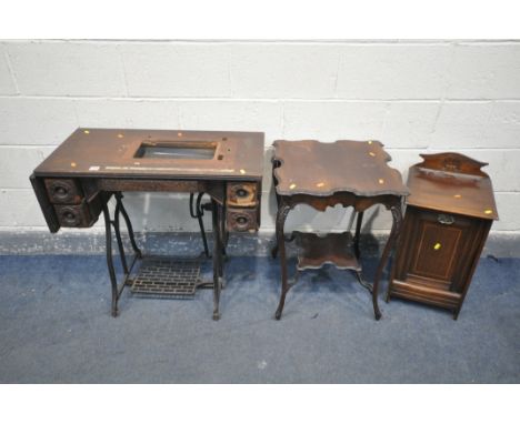 A VINTAGE TREADLE SEWING MACHINE (condition:-missing lid and machine, veneer loss) an Edwardian walnut purdonium and an Edwar
