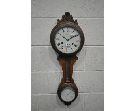 A LATE 19TH CENTURY ANEROID BAROMETER, with a 7 inch clock dial, behind a glass door, reading Seth Thomas, and roman numerals