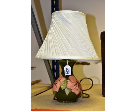 A MOORCROFT TABLE LAMP WITH A CREAM SHADE,  coral 'Hibiscus' pattern on a green ground, with a cream shade, height 23cm to to