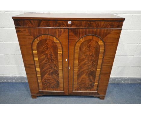 A 19TH CENTURY FLAME MAHOGANY TWO DOOR BOOKCASE, with three shelves, on bracket feet, width 124cm x depth 41cm x height 130cm