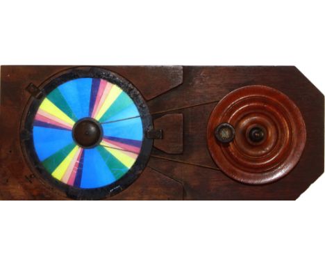 Colour wheel [rotates to show white]  Maker unknown (9 3/8 x 3 7/8 x 1/2 inches), pulley  *Notes- The colour wheel is a good 