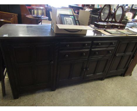 GOOD QUALITY LARGE ERCOL DRESSER FITTED CENTRALLY WITH FOUR DRAWERS OVER TWO CUPBOARD DOORS FLANKED EITHER SIDE WITH PANELLED